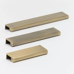 two brass drawer pulls on a white background