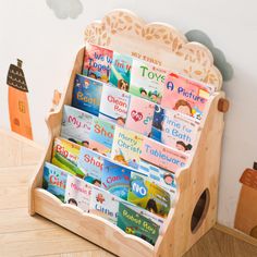 a wooden toy book stand with children's books in it