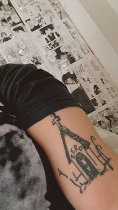 a person with a tattoo on their arm that has an image of a clock tower