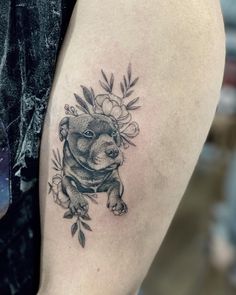 a black and white tattoo of a koala with flowers on it's thigh