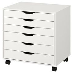 a white cabinet with five drawers and four black handles on casteors, isolated against a white background