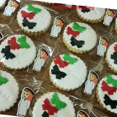 decorated cookies in the shape of snowmen with bows and hats are on plastic wrappers