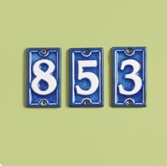 three blue and white numbered numbers on a green background, with the number 853