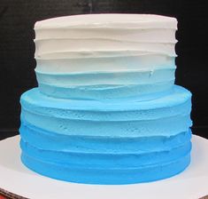 a blue and white layered cake sitting on top of a plate