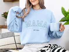 Our mama sweatshirt is the perfect gift for all moms! The style lettering will leave mama feeling cozy yet chic every day. Personalize the left sleeve with the names of the mother's children and/or loved ones to make it even more special. Item Details * Crewneck Sweater, 50% cotton, 50% polyester * Unisex Sizing: S, M, L, XL, 2XL, 3XL Care Instructions: Machine wash cold. Tumble dry low or hang to dry. Wash inside out. Do not iron or dry clean. Process & Shipping * Orders are typically processed and shipped within 1-3 business days. This may change during the holiday season, please view current posted processing times! Returns & Exchanges  Since items are made to order we do not accept returns or exchanges. Please make sure that your personalization information is correct and reach out if Cozy Blue Sweatshirt With Letter Print, Cozy Blue Top With Letter Print, Casual Sweatshirt For Birthday And Mother's Day, Blue Casual Sweatshirt For Gift, Casual Blue Sweatshirt For Gift, Blue Casual Sweatshirt As Gift, Mother's Day Relaxed Fit Sweatshirt For Loungewear, Relaxed Fit Sweatshirt For Mother's Day Loungewear, Casual Sweatshirt For Mother's Day Loungewear