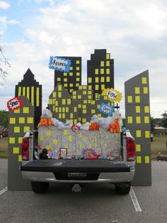 the back end of a pick up truck decorated with balloons and candy bar wrappers