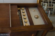 an old wooden table with buttons on it