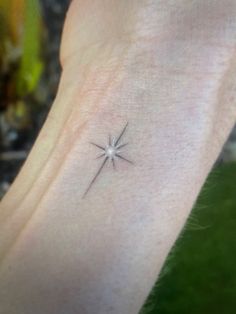 a small star tattoo on the ankle