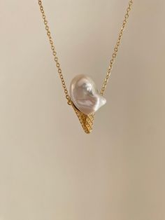 Bite me! Bring a touch of fun and whimsy to your jewelry collection with this unique waffle cone shaped pendant necklace. The pendant, made in the shape of an ice cream cone, is crafted from a natural baroque pearl, adding a touch of elegance and gold plated waffle cone, adding a touch of luxury to the piece. Perfect for summer days or for those who have a sweet tooth, this necklace is sure to bring a smile to anyone's face. Wear it to add a playful touch to your outfit, or give it as a gift to your favorite ice cream lover. Material Naturally hued freshwater cultured baroque pearls: about 20-23mm long and 15mm wide. The pearls were hand-picked from farmers directly. No color treatment was applied. All natural. Each one is unique and handmade by S.L.Pang. Designer S.L.Pang is an independen Pearl Necklace Designs Unique, Ice Cream Waffle Cone, Pearl Necklace Designs, Pearl Pendant Necklace, Jewelry Lookbook, Baroque Pearls, Pearl Pendant, Necklace Designs, Pearl Jewelry