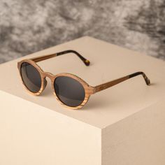 The Lagos unisex frame takes you back to the Algarve. Its smooth circular shape embodies the curves and gradients of that stunning landscape. Just as landscapes stand strong for thousands of years, we have crafted our sunglasses to be sturdy enough for all your travels. Whether you are running down hills or rushing through the city, the Lagos is your companion. Made with eco-friendly Zebrano and walnut wood, you are making your contribution to sustainable fashion. * 12 Months Guarantee * Every P Uk Design, Wooden Watches For Men, Stand Strong, Buy Watches, Wooden Watch, Sunglasses For Men, Optical Frames, Polarized Lenses, Algarve