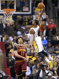 a basketball player jumping up to dunk the ball