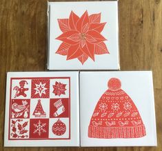 three cards with red and white designs on them