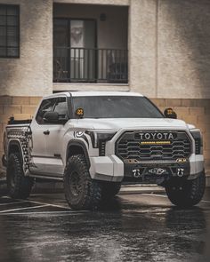 a white truck parked in front of a building