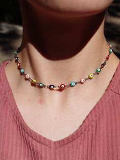 "Multicolor evil eye choker made from enamel beads and stainless-steel chain. These chokers are made with materials that ensure that the choker will not fade/react to water exposure. Each choker is 12 inches in length and comes with a 3-inch extension chain to extend the length if needed! Great for stacking with other necklaces and goes with any outfit!  Details: * Length: 12\" + 3-inch extension chain * Materials: Enamel, Stainless steel  * Closure: Lobster clasp * Ships within 3-5 days * Handmade item * Gift wrapping/birthday wrapping available for this item!  Please contact me with any questions or concerns, I'd be happy to help! :)" Rainbow Evil Eye, Indie Necklace, Evil Eye Choker, Birthday Wrapping, Y2k Jewelry, Enamel Beads, Hippie Necklace, Protection Necklace, Evil Eye Jewelry