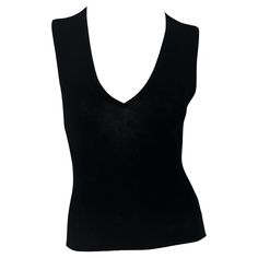 This chic black sleeveless knit top by Gucci, designed by Tom Ford for the Spring/Summer 1998 season, features a deep plunging v-neckline. Simple yet stylish, it's a timeless piece from Ford's era at Gucci. Approximate measurements: Size - M Shoulder to hem: 21" Bust: 28 - 34" Waist: 26 - 32" 100% silk Gucci Sleeveless Top For Summer, Gucci Black Top For Night Out, Gucci Fitted Sleeveless Top, Gucci By Tom Ford, Top Noir, Gucci T Shirt, Ford Black, Gucci Brand, Sleeveless Knit Top