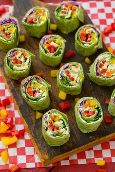 a wooden cutting board topped with lots of veggies