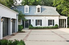 a white house with black shutters and windows