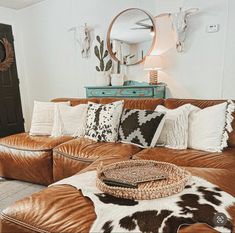 a living room filled with lots of brown furniture