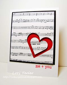 a card with music sheets and a red heart