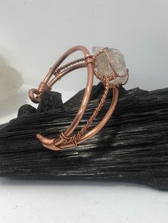 This original wire wrapped wearable wrist piece is a step in our evolutionary process as well as a new page in our revolutionary archive of original hand crafted wearable works. The gems are wrapped with our secure time tested low profile technique designed to highlight the stone, offer access to touch the gems surface, and fit comfortably on various body types. A solid copper bangle stabilizes the gems in a symmetric pattern, synchronizing the metal and stones in such a way that the piece gives Eyesight Improvement, Symmetric Pattern, Copper Chain Bracelet, Wire Jewelry Patterns, Wire Wrapped Jewelry Diy, Wrap Bangles, 2024 Design, Wire Jewelry Designs, Astral Travel