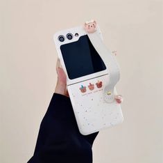 a person holding up a cell phone case that has cupcakes on the front