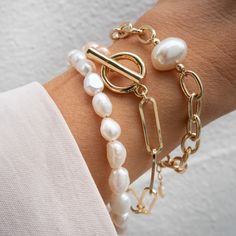 Our Cora Pearl Bracelet is so simple yet absolutely eye-catching. What do we love about it? This bracelet is timeless and modern - perfect as a gift or gifted to yourself! BRACELET FEATURES Small Genuine Freshwater Baroque Pearls Choice of Yellow Gold, Rose Gold or Sterling Silver Finish Bracelet includes a 1" extender All bracelet findings (clasp, end tags, jump rings) and extender chain are 100% gold filled or sterling silver to ensure the highest quality piece Bracelet available in 2 sizes: S Pearl Gold Bracelet Designs, Adjustable Chic Pearl Bracelet As Gift, Chic Adjustable Pearl Bracelet Gift, Chic Adjustable Pearl Bracelet As Gift, Modern Pearl Bracelet For Gift, Chic Jubilee Charm Bracelet As Gift, Chic Jubilee Charm Bracelet For Gift, Chic Jubilee Charm Bracelet Gift, Adjustable Modern Pearl Bracelet As Gift