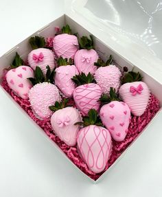 a box filled with pink chocolate covered strawberries