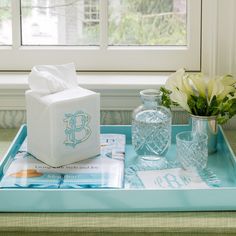 a tray with tissue, glasses and vases on it