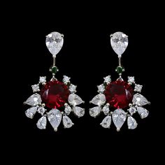 Ruby Diamond Earrings feature red gemstone and cubic zirconia diamond CZ in it. Handmade with care, they make a bold statement perfect for bridal wear or special occasions. Elegant and eye-catching, these dangle earrings are a beautiful wedding gift for her, adding glamour to any outfit. *𝐏𝐑𝐎𝐃𝐔𝐂𝐓 𝐃𝐄𝐓𝐀𝐈𝐋* * 𝐌𝐚𝐭𝐞𝐫𝐢𝐚𝐥: Brass * 𝐏𝐥𝐚𝐭𝐢𝐧𝐠: White Rhodium Plated * 𝐒𝐭𝐨𝐧𝐞: AAA-quality CZ diamond. *𝐃𝐈𝐌𝐄𝐍𝐒𝐈𝐎𝐍𝐒* * 𝐖𝐞𝐢𝐠𝐡𝐭: 8 gm each * 𝐋𝐞𝐧𝐠𝐭𝐡: 1.3 Inches * Red Diamond Drop Earrings, Red Ruby Diamond Earrings For Wedding, Red Diamond Drop Earrings For Formal Events, Red Diamond Drop Earrings For Formal Occasions, Formal Red Diamond Drop Earrings, Red Diamond Earrings For Wedding, Red Synthetic Ruby Earrings, Elegant Red Cluster Earrings For Wedding, Dazzling Red Earrings For Formal Occasions