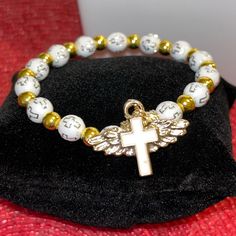 * Brand New! (Removed From Packaging For Photos) * Features A Cross Charm With Angel Wings. White Beading Also Feature Crosses And Are Accented With Gold Beading. * Bracelet Is A Stretch Bracelet (Os Fits Most) * Smoke Free Environment Thank You For Your Support Of My Small Business! I Ship Within 1-3 Business Days! Bundle Items For Deep Discounts! Angel Wings Gold, Gold Angel Wings, My Small Business, Christian Jewelry, Cross Charms, Stretch Bracelet, Gold Beads, Cute Jewelry, Angel Wings