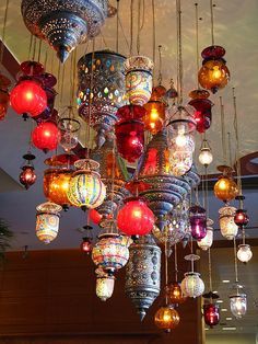 a large chandelier hanging from the ceiling in a room with many lights on it