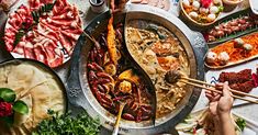 a table filled with lots of food and chopsticks