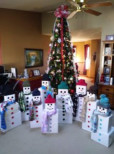 a christmas tree is decorated with snowmen and presents