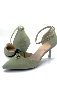 a pair of women's shoes with flowers on the heel and heels are shown