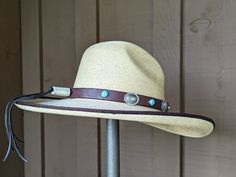 Five large sterling silver Conchos with a pop of color from 6 Kingman Turquoise stones that have set in sterling silver and mounted on new brown rein leather. Secures on your hat with deertan lace and an antler bead slider.The leather band is 3/4" wide and 23" in length.Hat not included. Adjustable Brown Hat Band With Concho, Adjustable Brown Western Jewelry, Southwestern Adjustable Concho Hat, Adjustable Southwestern Concho Hat, Western Silver Hat Bands For Festivals, Silver Western Hat Bands For Festival, Adjustable Silver Hat Band For Rodeo, Western Style Brown Jewelry For Western-themed Events, Bohemian Concho Hat Bands Adjustable