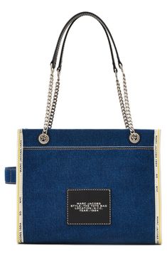 Chain carry handles and a denim exterior reimagine this iconic logo-marked tote that folds flat for storage or travel. Top zip closure Top carry handles Structured silhouette with flat base for stability Lined Textile Imported Medium Tote Bag, Iconic Logo, Logo Mark, Medium Tote, Blue Dark, Marc Jacobs, Handles, Nordstrom, Tote Bag