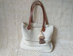 Handbags,crochet handbag,shoulder bag,white bag,women handbag,handbag with leather handles,handbag with brown handles,classic bag with tasel WE DO NOT SHIP THE GOODS TO THE UK AND GERMANY  Hand crocheted handbag, made of polyester rope with leather handles and bottom. Milky white colour with tassel. Hand wash only... Dimensions:  Height 28cm/11.03 in Width at the top 37cm/14.58 in Bottom 32 x7cm/12.61 x 2.76 in Handles 51cm/20.08 in The goods are carefully packaged and will be sent to You by Lithuanian Registered Mail. The shipping usually takes 1-3 weeks. However, because of the customs in some countries this could take a bit longer. Thanks for visiting my shop :) Yours, DVhandicrafts Crocheted Handbag, Handbags Crochet, Yellow Leather Bag, Felt Tote Bag, Blue Leather Bag, Boho Crossbody Bag, Felted Handbags, Crochet Handbag, Soft Leather Bag