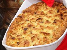 a casserole in a white dish with a red hat