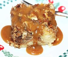 a piece of cake covered in caramel sauce on a white plate with a fork