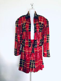 Amazing vintage two piece Modi sequins jacket and shorts. Festive and fun this set is perfect for the holiday season! The jacket has a full placket of buttons. The shorts are mid thigh length with a zipper and hook eye closure at the back as well as an elastic waist. Buffalo plaid with a hint of yellow. Silk, lined in rayon. Both marked size medium 8-10 C. 1980's-1990's. Jacket Measurements: Shoulder seam to shoulder seam: 19 inches, ample built in shoulder pads Length: 19 inches The following m Red Party Sets For Fall, Vintage Reworked Plaid Tops, Sequins Jacket, Retro Plaid Outerwear With Button Closure, Jacket And Shorts, Single-breasted Plaid Tweed Outerwear, Vintage Sequin Fitted Outerwear, Vintage Two Piece, Luxury Plaid Single-breasted Tweed Jacket