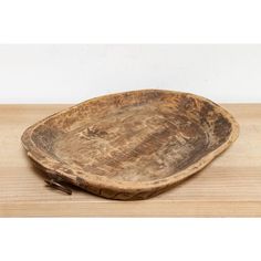 a wooden bowl sitting on top of a wooden table