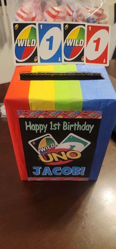 Uno themed gift card box. Used tissue paper. All 4 different colors of the cards. Purchased the printout on Etsy. Used the original UNO cards for decoration. Uno Card Themed First Birthday, Uno Party Favors, Trunk Party