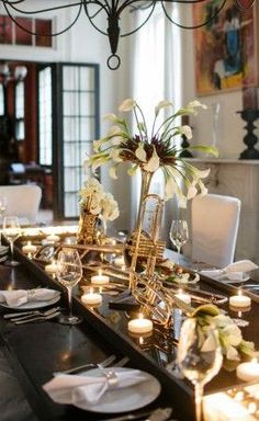 a dining room table is set with candles and flowers