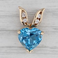 Gemstone Information: - Natural Topaz - Carats - 2.34ct  Cut - Heart Brilliant Color - Light Blue Treatment - Routinely Enhanced - Natural Diamonds - Total Carats - 0.04ctw Cut - Round Brilliant Color - G - H Clarity - I1 - I2 Metal: 14k Yellow Gold Weight: 1.6 Grams  Stamps: 14k p (P is for Plumb for high quality gold) Measurements: 15.7 x 9.1 mm The bail will accommodate up to a 2.3 mm chain. Each piece is thoroughly examined and refinished as needed by our professional jewelers, graded by our Greensboro Nc, Heart Diamond, Heart Pendant Diamond, Brilliant Colors, Diamond Pendant, Round Brilliant, Color Light, Blue Topaz, Pendant Necklaces