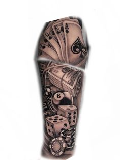 a man's leg with some dice and playing cards on it, while he is wearing