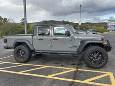 a gray jeep parked in a parking lot