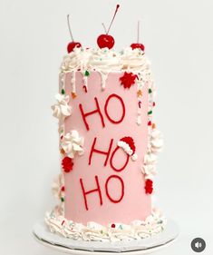 a pink birthday cake with white frosting and sprinkles that says ho hoo