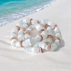 Handcrafted with meticulous care, this beach bracelet includes sea glass, aquamarine, shell, coconut, and unique fish bone vertebrae beads handmade in Africa. Each element tells a story of the sea, from the intricate fish bone bead to the shimmering sea glass bead, creating a unique piece that captures the essence of ocean treasures. The delicate coconut shell accents add a touch of sophistication, complementing the natural beauty of the shell bead to perfection. Perfect for a beach wedding or as a statement accessory for everyday wear, this bracelet evokes a sense of nautical allure. Measuring at a typical 7.25 inches, it offers a comfortable fit while showcasing its stunning design. Nautical enthusiasts and beach lovers alike will appreciate the intricate craftsmanship and attention to d Unique Fish, Beach Wedding Jewelry, Beach Bracelet, Ocean Treasures, Beach Lover Gifts, Beach Bracelets, Nautical Jewelry, Beach Lover, Shell Bracelet