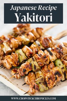 some skewered food is on a plate with chopsticks and the words, japanese recipe yakitorii