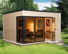 a small wooden shed with sliding glass doors